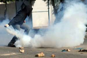 A Tunisian demonstrator prepares to throw a tear-gas canister during clashes with security forces in Regueb, near Sidi Bouzid in January 2011 -- the uprising in Tunisia signalled the start of the Arab Spring. By STR (AFP/File)