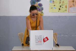 A Tunisian voter casts her ballot for presidential election at a polling station in Sousse, south of the capital Tunis, on Sunday. By ANIS MILI (AFP)