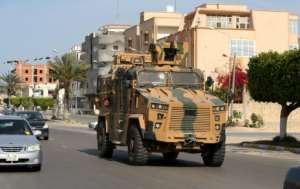 A Turkish-made armoured personnel vehicle drives through the Libyan coastal city of Sorman Monday after the unity government seized it from troops backing military commander Khalifa Haftar. By Mahmud TURKIA (AFP)