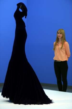 A visitor looks at a dress designed by Azzedine Alaia at the Museum NRW-Forum in Duesseldorf, Germany on June 11, 2013