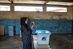 A woman casts her ballot in early voting on Zanzibar where oppoosition leader Seif Sharif Hamad has been arrested a day before Tanzania's election. By MARCO LONGARI (AFP)