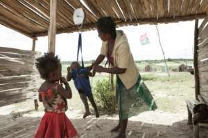 A woman checks the weight of her baby at the health center of the village of Imongy, in southern Madagascar in March 2015