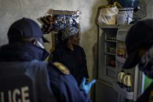 A woman is questioned about the contents of her fridge. Food, more than electronic goods, accounted for most of items that were confiscated on Tuesday. By MARCO LONGARI (AFP)