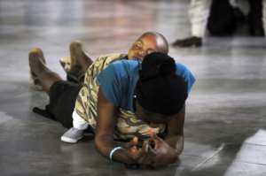 A woman prays with her baby on her back at a past crossover service at Lagos' Redemption Camp, a Nigerian Pentecostal church. By PIUS UTOMI EKPEI (AFP)