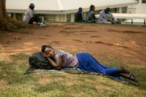 A woman rests as she waits for treatment at Mulago hospital, a hub for treating cancer patients across east Africa