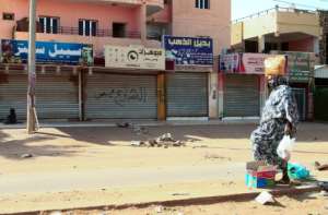 A woman walks past shuttered shops in the Sudanese capital Khartoum on October 28, 2021, four days after the army seized power in a coup that triggered unrest. By - (AFP)