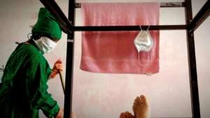 A worker cleans a room in a COVID-19 isolation center in Havana, Cuba. By YAMIL LAGE (AFP)