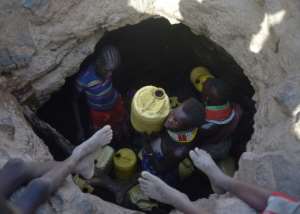 A young girl passes up a jerrycan filled with murky water from underground rocks in northern Kenya's Turkana county. A crippling drought ravaged the livestock population last year