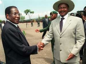 A younger Robert Mugabe with Uganda's President Yoweri Museveni. By ALESSANDRO ABBONIZIO (AFP/File)