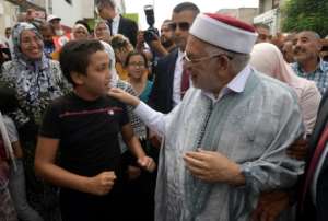 Abdelfattah Mourou of the Islamist-inspired Ennahdha party campaigns in the poverty-stricken Tunis suburb of Ettadhamen ahead of Sunday's presidential poll. By FETHI BELAID (AFP)