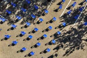 Aerial view of chairs arranged in order to maintain social distancing at a parking lot in Soweto for food distribution. By MARCO LONGARI (AFP)