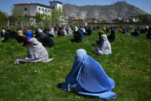 Afghans wait to receive free wheat from the government emergency committee during a novel coronavirus lockdown on the capital Kabul. By WAKIL KOHSAR (AFP)