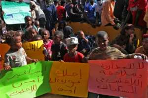 African migrants demonstrate outside the Tripoli office of the UN refugee agency demanding repatriation after Friday's shooting deaths again highlighted the appalling conditions they endure in Libya. By Mahmud TURKIA (AFP)