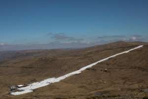 Afriski's main kilometre-long piste is a strip of brilliant white snow between brown grassy ridges.  By MARCO LONGARI (AFP)