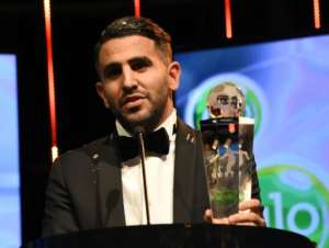 Algerian and Leicester forward Riyad Mahrez holds his trophy after being crowned African Footballer of the Year, in Abuja, on January 5, 2017