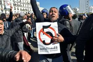 Algerian policemen surround protesters on February 22, 2019 during a demonstration against Bouteflika's candidacy for a fifth term. By RYAD KRAMDI (AFP/File)