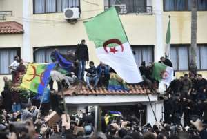 Algerian protesters have flown the Berber flag at demonstrations against presidential elections, despite a ban on symbols 'undermining national unity'. By RYAD KRAMDI (AFP)