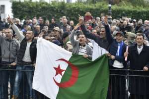 Algerian protesters shouted slogans supporting the upcoming elections near an anti-government demonstration in Algiers on December 9. By RYAD KRAMDI (AFP/File)