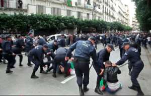 Algerian security forces detain polling day protesters in the capital Algiers. By Yacine BENRABIA (AFP)