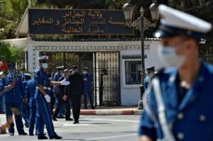 Algerian security forces stand guard outside the El-Alia cemetary where Abdelaziz Bouteflika, the North African country's longest-serving president, is set to be buried in the capital Algiers on September 19, 2021. By RYAD KRAMDI (AFP)