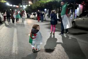 Algerians celebrate Bouteflika's resignation on April 2 last year. By RYAD KRAMDI (AFP/File)