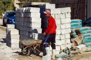 An Egyptian construction labourer works in an illegal construction project in Benghazi. By Abdullah DOMA (AFP)