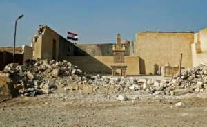 An Egyptian flag behind a grave marker, exposed by the destruction of a surrounding wall in the historic City of the Dead necropolis in Egypt's capital Cairo. By Khaled DESOUKI (AFP)