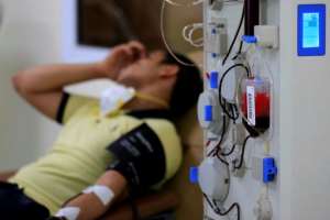 An Egyptian man who recovered from Covid-19 donates blood at the National Blood Transfusion centre in Cairo. By Khaled DESOUKI (AFP/File)