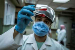 An Egyptian medical worker checks blood donated from a person who recovered from Covid-19 inless at the National Blood Transfusion centre in Cairo. By Khaled DESOUKI (AFP)