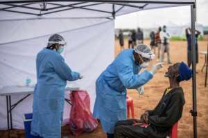 An elderly man, a resident of the sprawling township of Alexandra in Johannesburg, is tested for COVID-19. By MARCO LONGARI (AFP/File)
