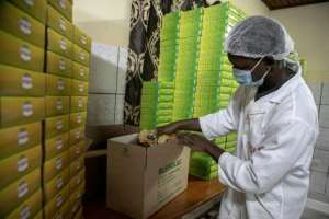 An employee packs a box at cereal manufacturer and MIC business Blesolac in Douala. By Daniel Beloumou Olomo (AFP)