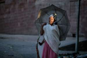 An Ethiopian Orthodox devotee in a street of Lalibela. Residents say they endured four months of deprivation and violence after rebels seized the town. By Solan Kolli (AFP)