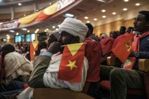 An Ethiopian Orthodox priest holds a Tigray flag during a Tigray People's Liberation Front (TPLF) congress in January. By EDUARDO SOTERAS (AFP)