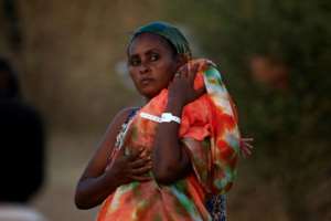 An Ethiopian mother carries her baby in the Um Raquba refugee camp in eastern Sudan, where she fled to from fighting in her homeland of Tigray; healthcare facilities are severely limited. By ASHRAF SHAZLY (AFP)