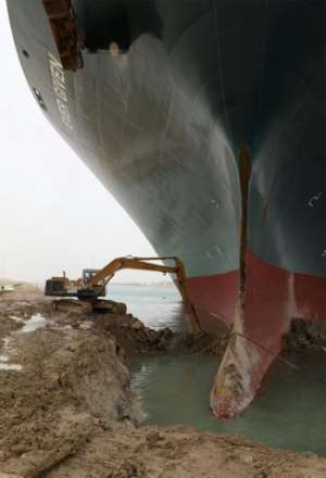 An excavator is used to dig out the Ever Given, a 400-metre- (1,300-foot) long vessel lodged across Egypt's Suez Canal. By - (Suez CANAL/AFP)
