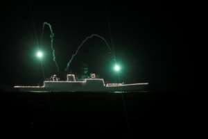 An Indian navy ship anchored off the coast of Chennai is illuminated in tribute to those fighting against the spread of COVID-19. By Arun SANKAR (AFP)