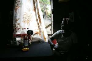 An Onesime family member sits in the kitchen of the house she shares with 26 other family members in Port Louis, Mauritius, in 2005; the Onesime family, originally from Diego Garcia in the Chagos were forcibly removed by the British in 1971. By MARCO LONGARI (AFP/File)