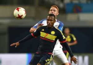 Andres Cifuentes (front) of Colombia and Josh Sargent (R) of USA vie for a ball during their group stage match which Colombia won 3-1