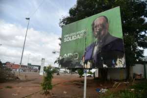 Anger: A poster of President Alassane Ouattara after clashes in Yamoussoukro following the October 31 elections. By SIA KAMBOU (AFP)