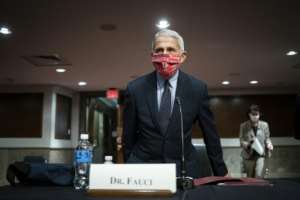 Anthony Fauci, the top US infectious disease expert, has warned that the country is still 'knee-deep' in its first coronavirus wave. By POOL (GETTY IMAGES NORTH AMERICA/AFP)