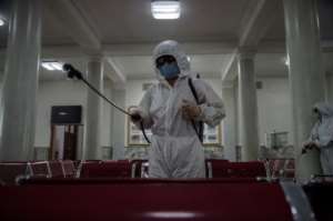 'Anti epidemic officials' were seen spraying disinfectant at Pyongyang Railway Station. By KIM Won Jin (AFP)