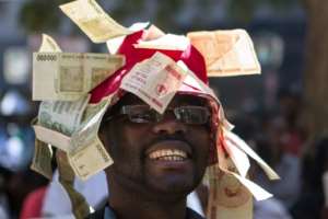 Attempts by African countries to get around fiscal constraints didn't always end well, such as this Zimbabwean man who decorated his hat with worthless currency. By ZINYANGE AUNTONY (AFP/File)