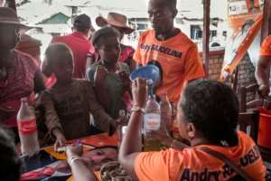 Backers of both candidates have been currying favour with voters among the poorest in Africa and here a young girl buys oil at a very low price from the supporters' headquarters of Rajoelina.  By RIJASOLO (AFP)