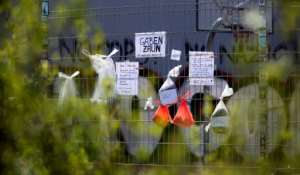 Bags with food and clothes donated for homeless people hang on a so-called gift fence in Leipzig, eastern Germany. By Ronny Hartmann (AFP)