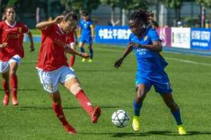 Barbra Banda (right) of Shanghai Shengli is challenged by Huang Wang of Changchun Zhuoyue. By STR (AFP)