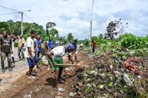 Beautification: local residents clear roadside rubbish ahead of Gbagbo's homecoming. By SIA KAMBOU (AFP)