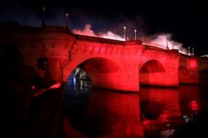 Bodies were thrown into the River Seine, here illuminated in red after a ceremony to commemorate the brutal repression of October 17, 1961. By JULIEN DE ROSA (AFP)