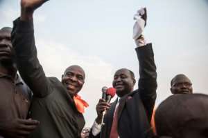 Bozize (L) briefly addressed the crowd that had turned out to welcome him. By FLORENT VERGNES (AFP)