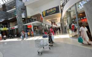 Blackouts often cost retailers several hours of business per day. By ALEXANDER JOE (AFP)