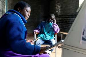 Blessing Chingwaru, an HIV positive and TB patient, has a consultation with a nurse at the Rutsanana clinic. By Jekesai NJIKIZANA (AFP)